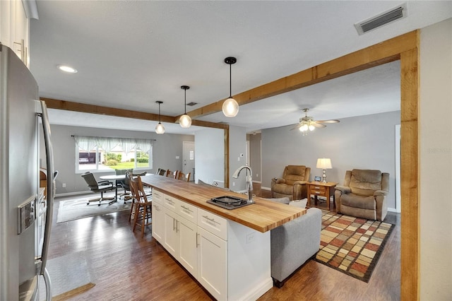 2914 Forest Cir, Seffner, FL 33584 - kitchen featuring butcher block countertops, stainless steel fridge, white cabinets, open floor plan, and dark wood finished floors