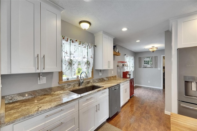 2914 Forest Cir, Seffner, FL 33584 - kitchen with stainless steel appliances, wood finished floors, white cabinets, light stone counters, and recessed lighting
