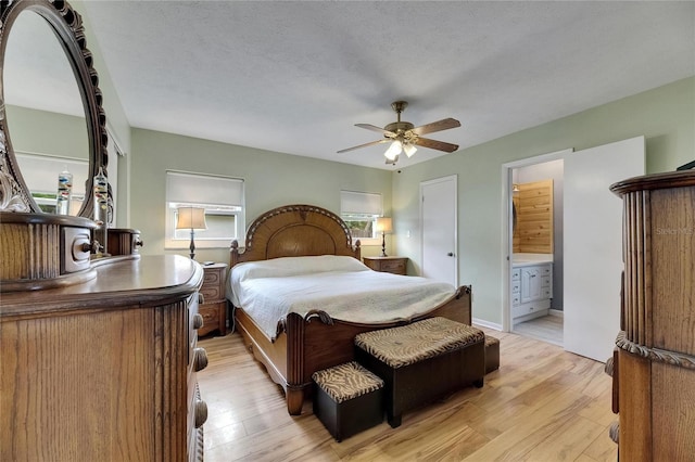 2914 Forest Cir, Seffner, FL 33584 - bedroom with light wood finished floors, ensuite bathroom, and a ceiling fan