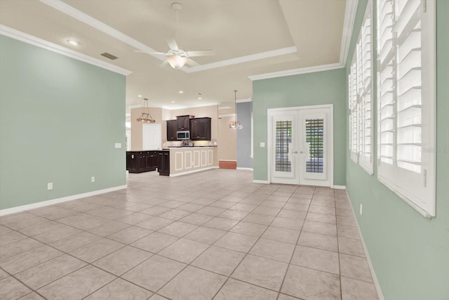 13321 Lewis Raulerson Rd, Dover, FL 33527 - unfurnished living room with french doors, light tile patterned flooring, a ceiling fan, crown molding, and a raised ceiling