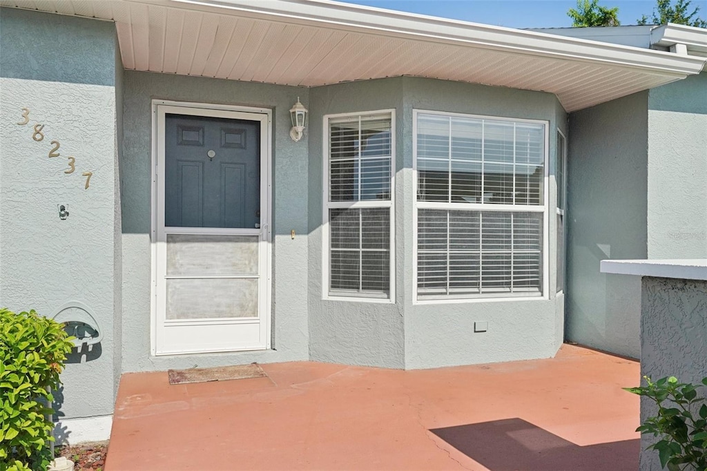 38237 Eucalyptus Dr, Zephyrhills, FL 33542 - entrance to property featuring stucco siding