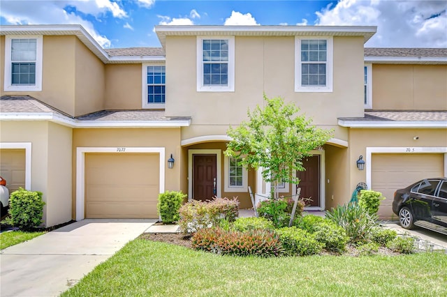 7077 Woodchase Glen Dr, Riverview, FL 33578 - townhome / multi-family property with stucco siding, an attached garage, driveway, and a shingled roof