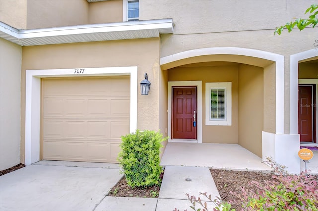 7077 Woodchase Glen Dr, Riverview, FL 33578 - view of exterior entry with stucco siding and an attached garage