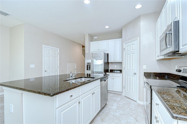 7077 Woodchase Glen Dr, Riverview, FL 33578 - kitchen featuring stainless steel appliances, an island with sink, white cabinetry, dark stone counters, and recessed lighting