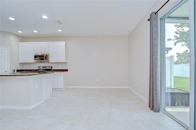 7077 Woodchase Glen Dr, Riverview, FL 33578 - kitchen featuring stainless steel microwave, range with electric stovetop, white cabinets, and recessed lighting