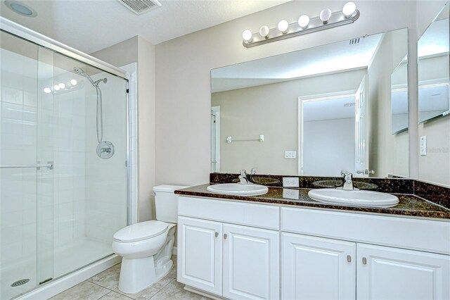 7077 Woodchase Glen Dr, Riverview, FL 33578 - full bathroom featuring double vanity, a shower stall, and tile patterned floors