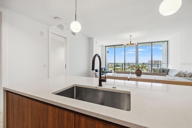 777 3rd Ave N Unit 1406, Saint Petersburg, FL 33701 - kitchen with hanging light fixtures, open floor plan, light stone counters, and a wall of windows