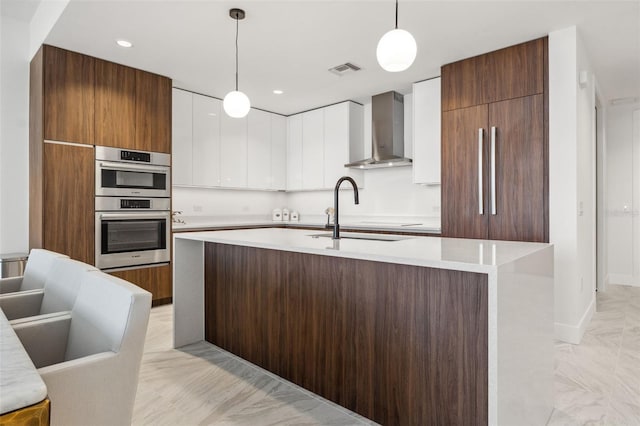 777 3rd Ave N Unit 1406, Saint Petersburg, FL 33701 - kitchen featuring wall chimney exhaust hood, double oven, modern cabinets, white cabinets, and light countertops