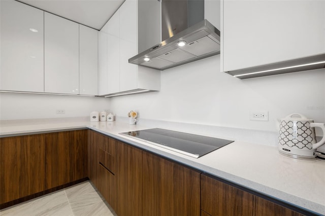 777 3rd Ave N Unit 1406, Saint Petersburg, FL 33701 - kitchen with wall chimney exhaust hood, black electric cooktop, modern cabinets, and white cabinets