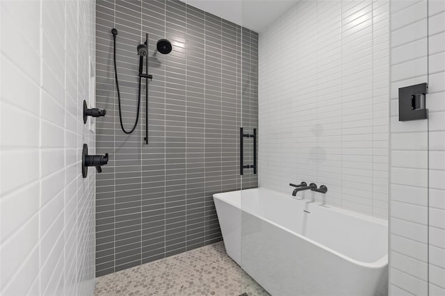 777 3rd Ave N Unit 1406, Saint Petersburg, FL 33701 - full bathroom featuring tile walls, a tile shower, and a soaking tub