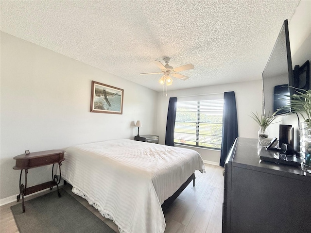 10636 Millriver Dr, New Port Richey, FL 34654 - bedroom featuring a textured ceiling, wood finished floors, and ceiling fan