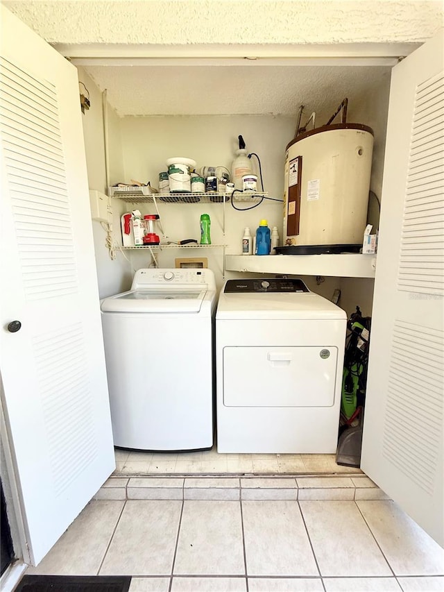 10636 Millriver Dr, New Port Richey, FL 34654 - washroom featuring electric water heater, washing machine and clothes dryer, and light tile patterned flooring