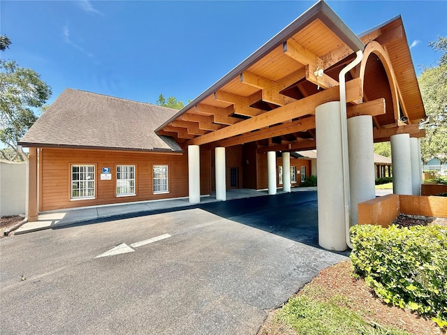 10636 Millriver Dr, New Port Richey, FL 34654 - view of building exterior with a carport and asphalt driveway