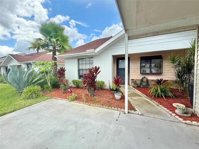 10636 Millriver Dr, New Port Richey, FL 34654 - view of front facade with stucco siding and a patio area