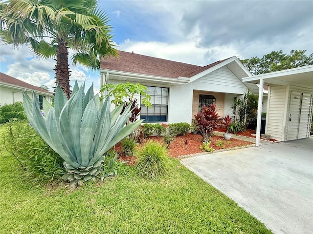 10636 Millriver Dr, New Port Richey, FL 34654 - view of front of property with stucco siding and a front yard