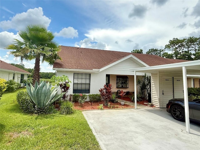 10636 Millriver Dr, New Port Richey, FL 34654 - view of front of property featuring a front lawn, a carport, and a shingled roof