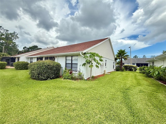 10636 Millriver Dr, New Port Richey, FL 34654 - view of property exterior with a yard and stucco siding