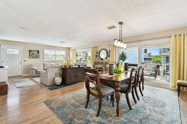 616 2nd St, Indian Rocks Beach, FL 33785 - dining space with a textured ceiling and light wood-style flooring