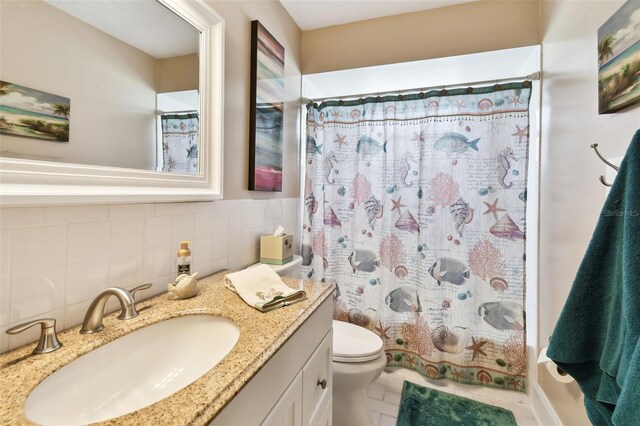 616 2nd St, Indian Rocks Beach, FL 33785 - full bathroom featuring vanity, shower / bathtub combination with curtain, and tile patterned floors