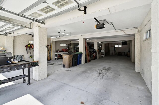 616 2nd St, Indian Rocks Beach, FL 33785 - garage featuring a garage door opener and a workshop area