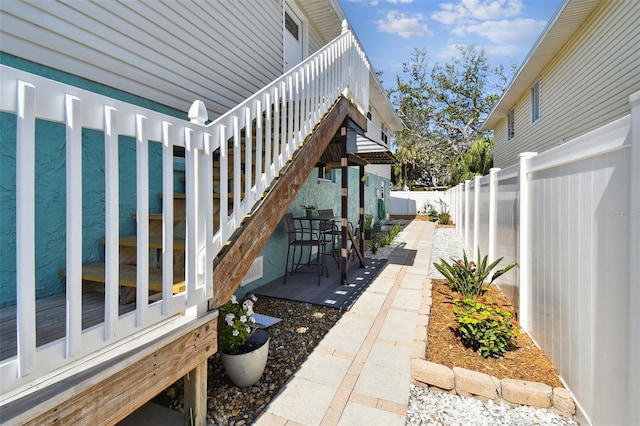 616 2nd St, Indian Rocks Beach, FL 33785 - view of home's exterior with a fenced backyard, a patio area, and stairway