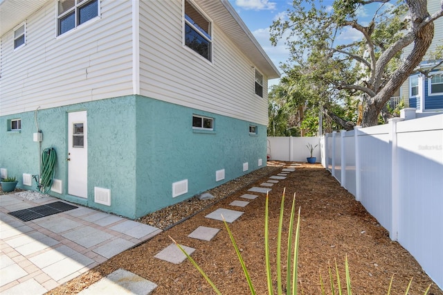 616 2nd St, Indian Rocks Beach, FL 33785 - view of home's exterior featuring a fenced backyard and stucco siding