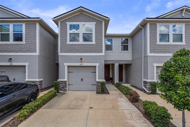 5813 Grand Sonata Ave, Lutz, FL 33558 - view of property with stucco siding, concrete driveway, an attached garage, and stone siding