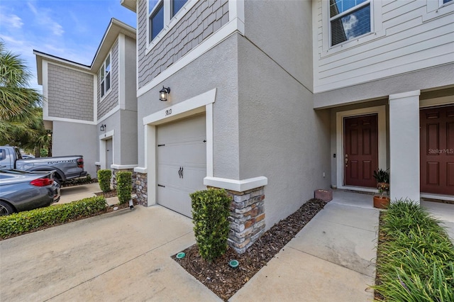 5813 Grand Sonata Ave, Lutz, FL 33558 - property entrance featuring stucco siding, a garage, driveway, and stone siding