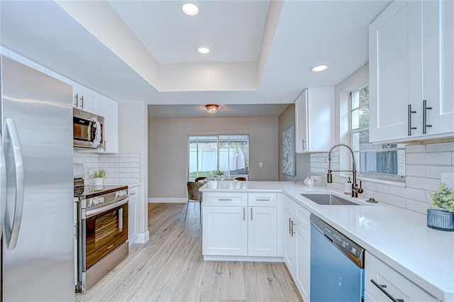 6720 Gilda Dr, Tampa, FL 33625 - kitchen with stainless steel appliances, light countertops, white cabinets, decorative backsplash, and recessed lighting