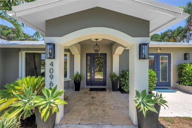 4096 38th St S, Saint Petersburg, FL 33711 - view of exterior entry with stucco siding and french doors