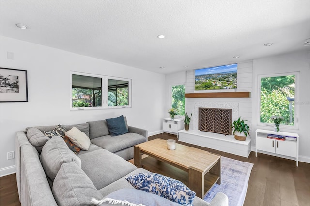 4096 38th St S, Saint Petersburg, FL 33711 - living room with a textured ceiling, recessed lighting, wood finished floors, and a fireplace