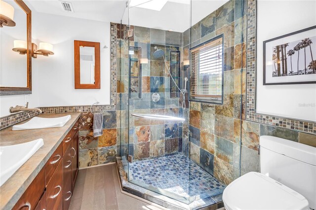 4096 38th St S, Saint Petersburg, FL 33711 - bathroom featuring tile walls, double vanity, and a stall shower