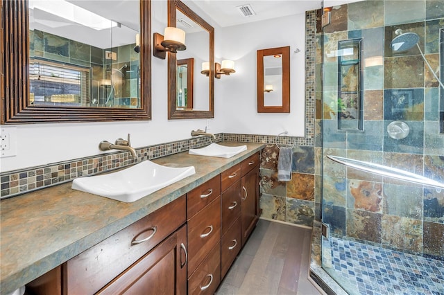 4096 38th St S, Saint Petersburg, FL 33711 - full bath with double vanity, a shower stall, wood finished floors, and tile walls