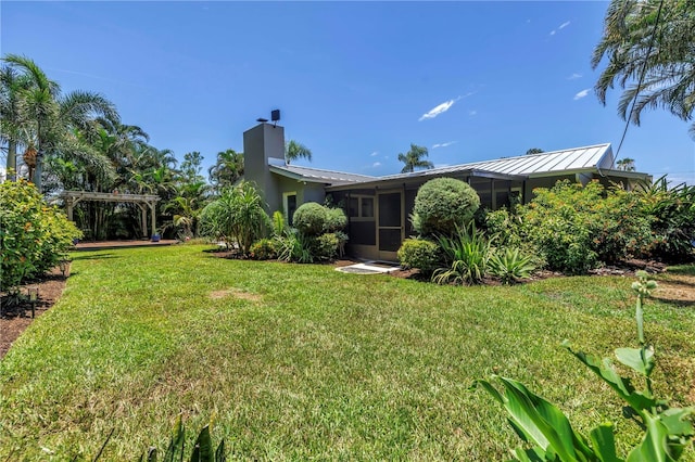4096 38th St S, Saint Petersburg, FL 33711 - view of green lawn featuring a sunroom and a pergola