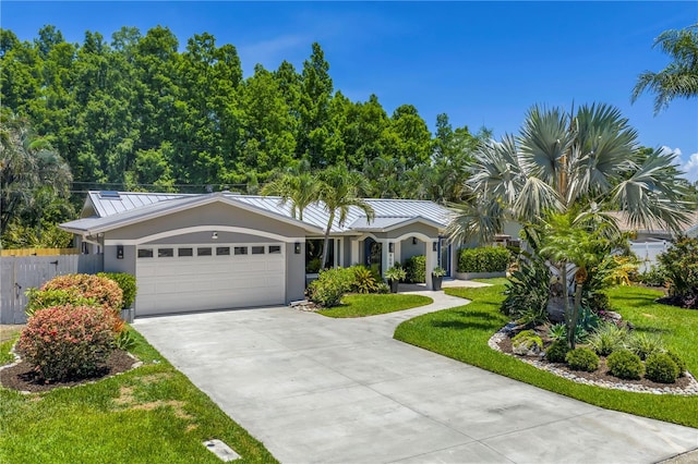 4096 38th St S, Saint Petersburg, FL 33711 - ranch-style home with a standing seam roof, stucco siding, driveway, a garage, and a metal roof