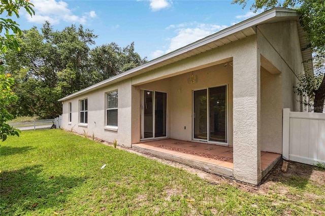 818 Cherry Laurel St, Minneola, FL 34715 - rear view of house featuring stucco siding and a patio