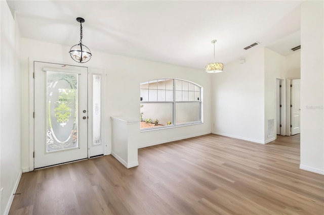 818 Cherry Laurel St, Minneola, FL 34715 - foyer with wood finished floors and a chandelier
