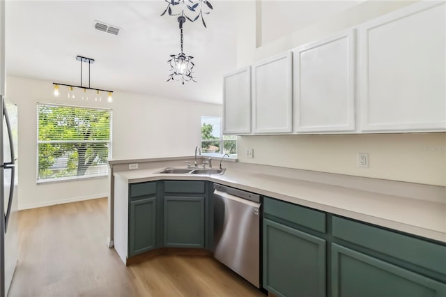 818 Cherry Laurel St, Minneola, FL 34715 - kitchen featuring stainless steel appliances, light wood-style floors, light countertops, and hanging light fixtures