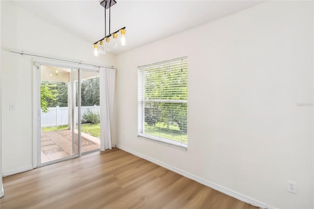 818 Cherry Laurel St, Minneola, FL 34715 - unfurnished dining area with healthy amount of natural light and wood finished floors