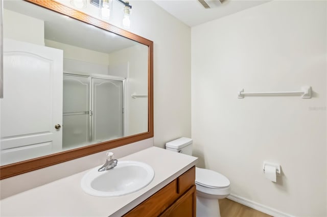 818 Cherry Laurel St, Minneola, FL 34715 - bathroom featuring vanity, a shower with door, and wood finished floors