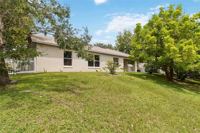 818 Cherry Laurel St, Minneola, FL 34715 - rear view of property featuring stucco siding