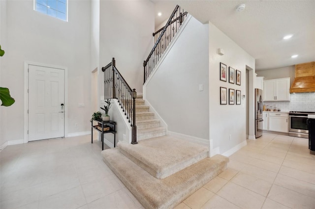 18144 Frame Bnd, Land O Lakes, FL 34638 - foyer featuring stairway, light tile patterned floors, recessed lighting, and a towering ceiling