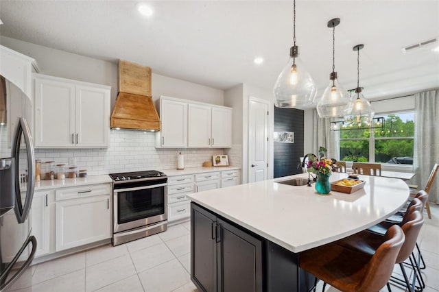 18144 Frame Bnd, Land O Lakes, FL 34638 - kitchen with appliances with stainless steel finishes, custom range hood, backsplash, light countertops, and white cabinets