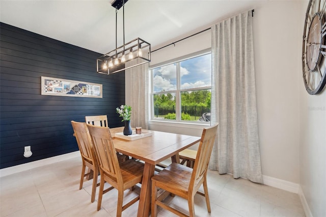 18144 Frame Bnd, Land O Lakes, FL 34638 - dining area with wooden walls, a chandelier, and light tile patterned floors