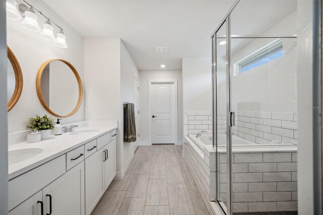 18144 Frame Bnd, Land O Lakes, FL 34638 - bathroom featuring double vanity, a stall shower, a garden tub, and recessed lighting