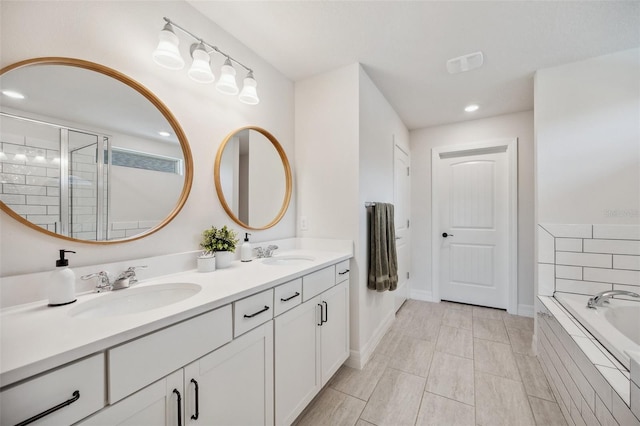 18144 Frame Bnd, Land O Lakes, FL 34638 - full bathroom featuring double vanity, a garden tub, recessed lighting, and a tile shower
