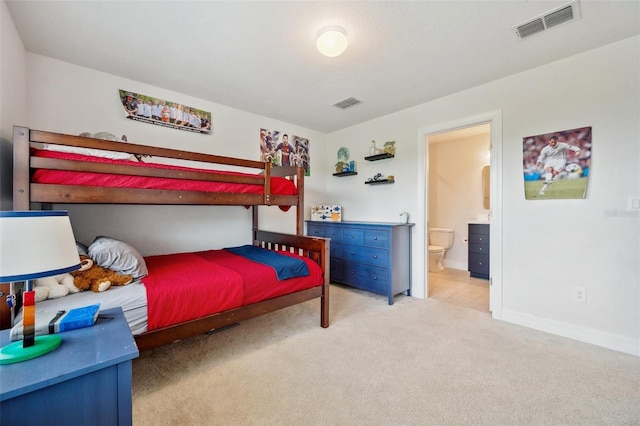 18144 Frame Bnd, Land O Lakes, FL 34638 - carpeted bedroom featuring ensuite bathroom and baseboards