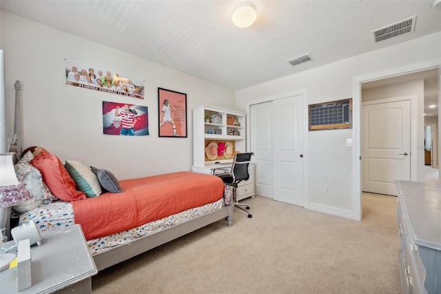 18144 Frame Bnd, Land O Lakes, FL 34638 - bedroom with light colored carpet, a closet, a textured ceiling, and an office area