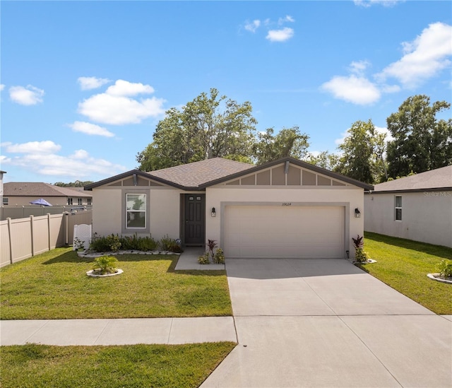 39024 Harlow Rose Dr, Zephyrhills, FL 33540 - view of front facade with a garage, driveway, and stucco siding