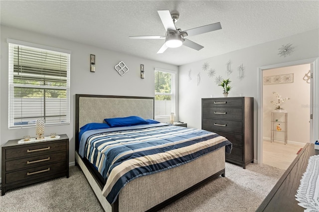 39024 Harlow Rose Dr, Zephyrhills, FL 33540 - bedroom with light colored carpet, a textured ceiling, and ceiling fan